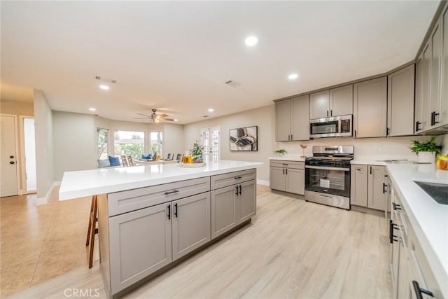6367 Willow Ave, Rialto, CA 92377 - kitchen with stainless steel appliances, gray cabinets, recessed lighting, and light countertops