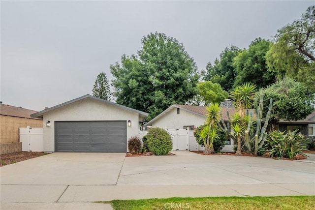 6367 Willow Ave, Rialto, CA 92377 - view of front of home with a gate, driveway, stucco siding, and a garage