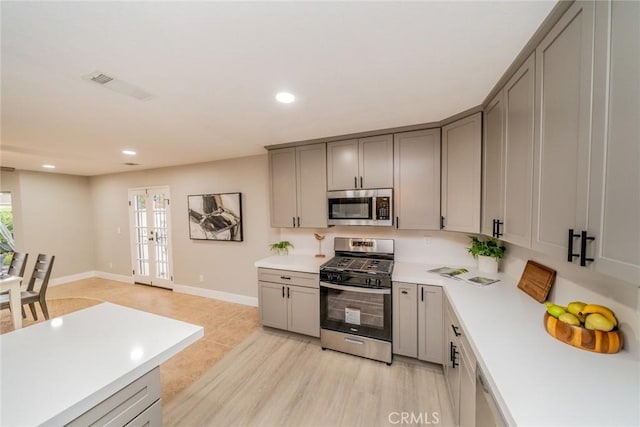 6367 Willow Ave, Rialto, CA 92377 - kitchen with stainless steel appliances, gray cabinets, light countertops, healthy amount of natural light, and recessed lighting