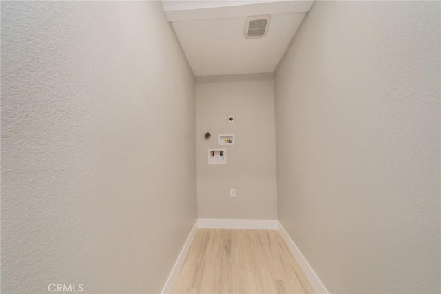 6367 Willow Ave, Rialto, CA 92377 - laundry area with hookup for an electric dryer, light wood-style floors, washer hookup, and a textured wall