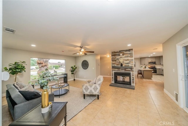 6367 Willow Ave, Rialto, CA 92377 - living room featuring a multi sided fireplace, ceiling fan, light tile patterned floors, and recessed lighting