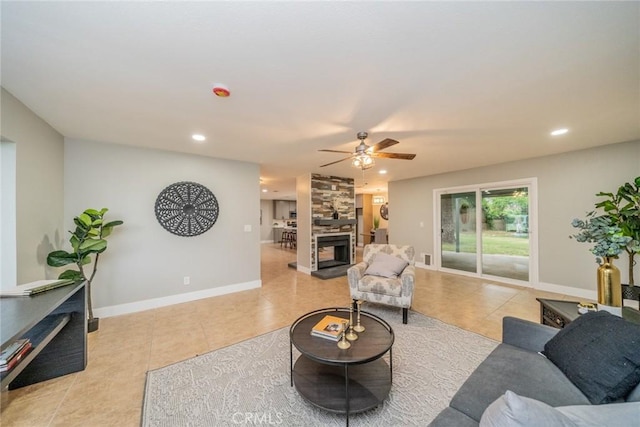 6367 Willow Ave, Rialto, CA 92377 - living room with light tile patterned floors, a ceiling fan, a stone fireplace, and recessed lighting