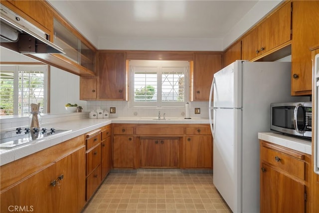 920 Wildrose, Brea, CA 92821 - kitchen with stainless steel microwave, cooktop, range hood, and brown cabinets