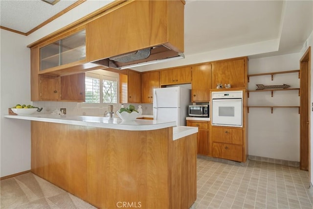 920 Wildrose, Brea, CA 92821 - kitchen featuring white appliances, a peninsula, light countertops, brown cabinets, and crown molding