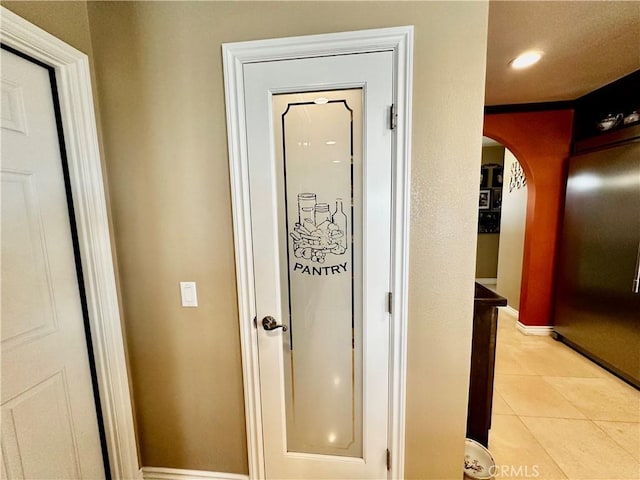 7562 Dartmouth Ave, Rancho Cucamonga, CA 91730 - corridor featuring arched walkways, light tile patterned floors, baseboards, and recessed lighting