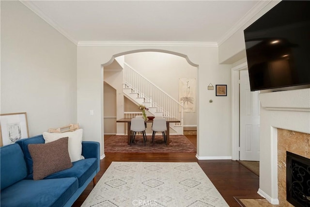 367 Caminito Barcelona, Chula Vista, CA 91914 - living area with stairway, dark wood-type flooring, a tiled fireplace, ornamental molding, and arched walkways