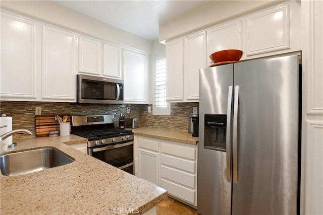 367 Caminito Barcelona, Chula Vista, CA 91914 - kitchen with appliances with stainless steel finishes, decorative backsplash, white cabinets, and light stone countertops