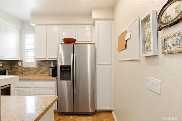 367 Caminito Barcelona, Chula Vista, CA 91914 - kitchen featuring stainless steel refrigerator with ice dispenser, white cabinetry, and backsplash