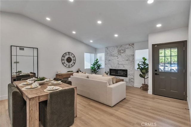 16409 Barbee St, Fontana, CA 92336 - living room featuring vaulted ceiling, healthy amount of natural light, a high end fireplace, recessed lighting, and light wood-style floors
