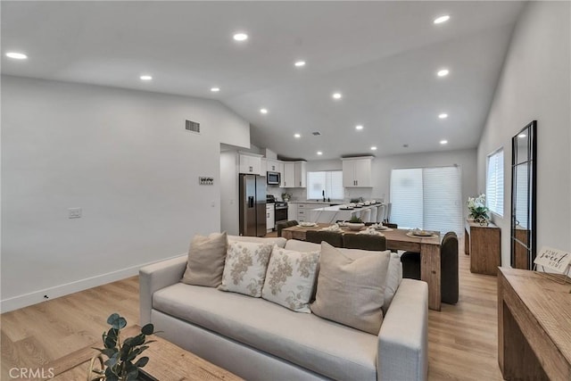 16409 Barbee St, Fontana, CA 92336 - living area with high vaulted ceiling, light wood-type flooring, and recessed lighting