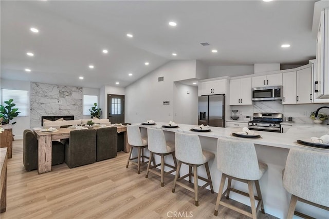 16409 Barbee St, Fontana, CA 92336 - kitchen with stainless steel appliances, open floor plan, light countertops, plenty of natural light, and vaulted ceiling