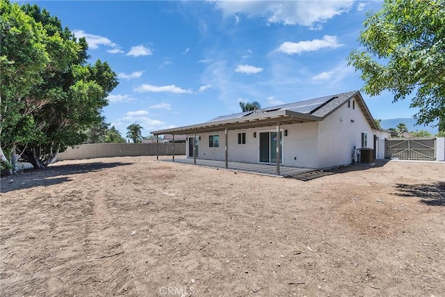 16409 Barbee St, Fontana, CA 92336 - back of house with solar panels, a fenced backyard, a patio, and stucco siding