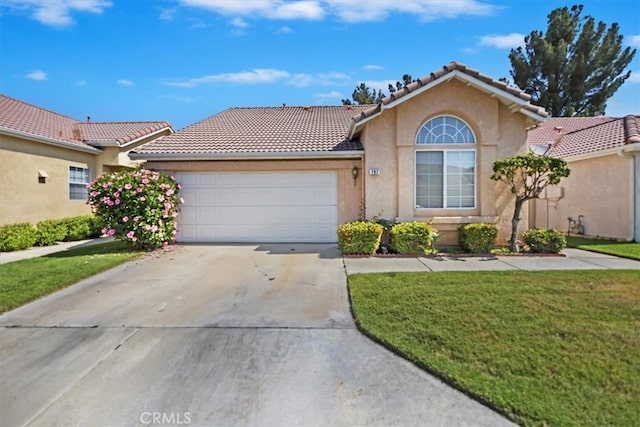 797 Camino De Plata, San Jacinto, CA 92583 - view of front of home with stucco siding, a tiled roof, concrete driveway, a garage, and a front yard