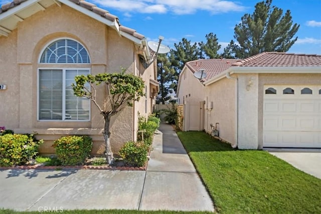 797 Camino De Plata, San Jacinto, CA 92583 - view of home's exterior with a tile roof, stucco siding, and a garage