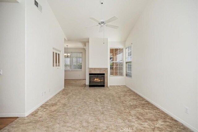 797 Camino De Plata, San Jacinto, CA 92583 - unfurnished living room with ceiling fan, a tile fireplace, carpet floors, a chandelier, and vaulted ceiling