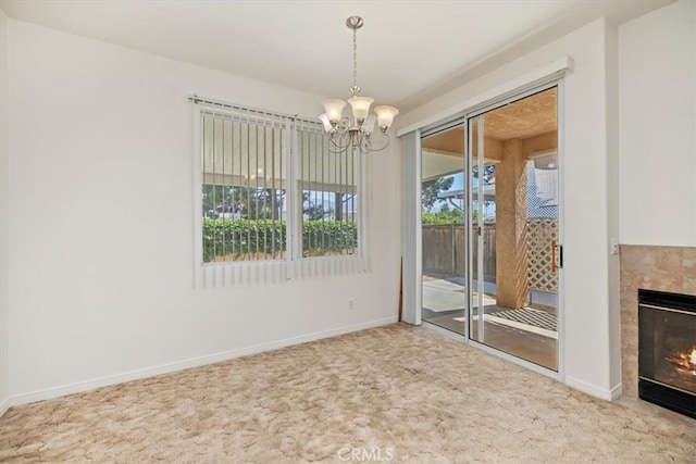 797 Camino De Plata, San Jacinto, CA 92583 - unfurnished dining area featuring carpet, a chandelier, and a tile fireplace
