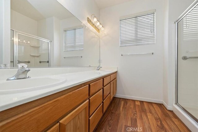 797 Camino De Plata, San Jacinto, CA 92583 - bathroom with a shower stall, wood finished floors, double vanity, and plenty of natural light