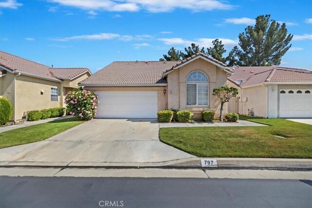 797 Camino De Plata, San Jacinto, CA 92583 - view of front facade with a tile roof, an attached garage, driveway, a front yard, and stucco siding
