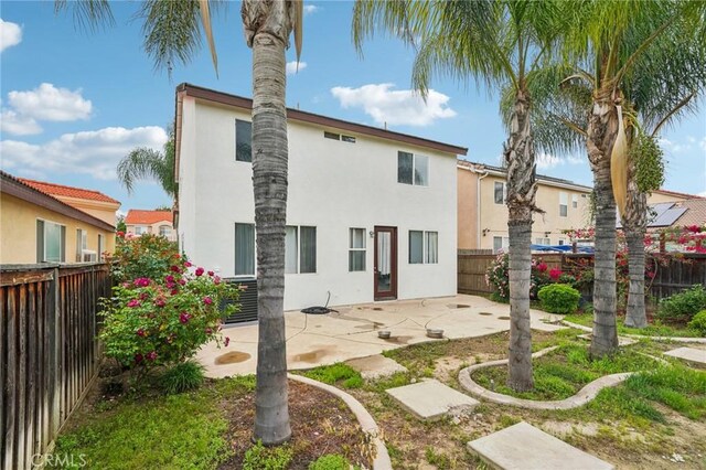 1109 Leopard Ln, Perris, CA 92571 - back of house with stucco siding, a patio area, and a fenced backyard