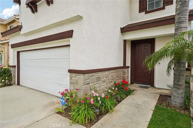 1109 Leopard Ln, Perris, CA 92571 - property entrance with stucco siding, an attached garage, and stone siding