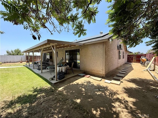 24859 Rock Springs Trl, Moreno Valley, CA 92557 - rear view of property featuring stucco siding, a patio, and roof mounted solar panels