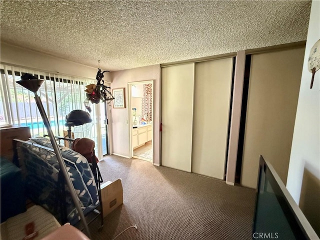24859 Rock Springs Trl, Moreno Valley, CA 92557 - carpeted bedroom featuring a textured ceiling, ensuite bathroom, and multiple closets
