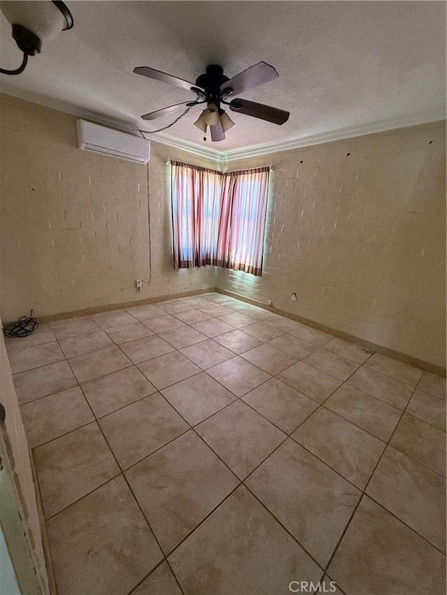 6733 Tamarisk Ave Unit 29, Palms, CA 92277 - unfurnished room featuring a wall mounted AC, ornamental molding, a ceiling fan, brick wall, and light tile patterned floors
