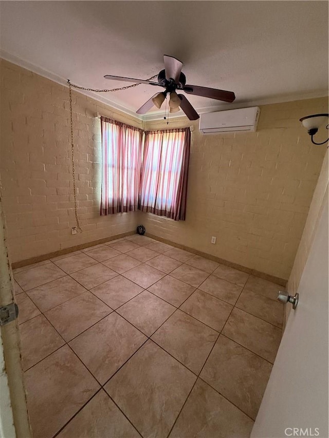 6733 Tamarisk Ave Unit 29, Palms, CA 92277 - spare room with an AC wall unit, a ceiling fan, tile patterned flooring, and brick wall