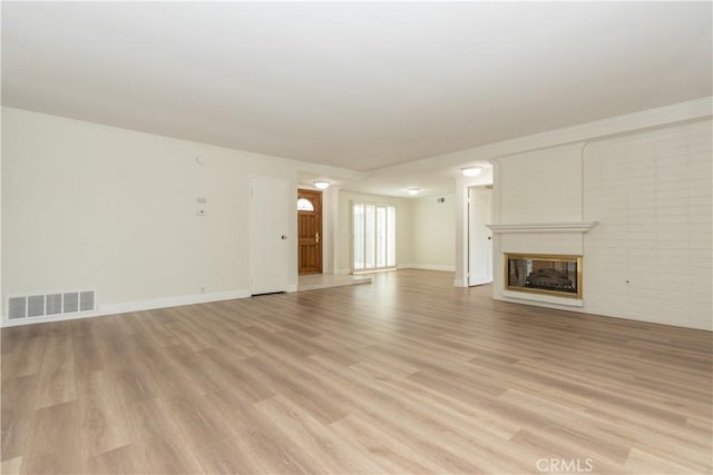 24912 Delos Ave, Mission Viejo, CA 92691 - unfurnished living room with a glass covered fireplace, light wood finished floors, baseboards, and crown molding