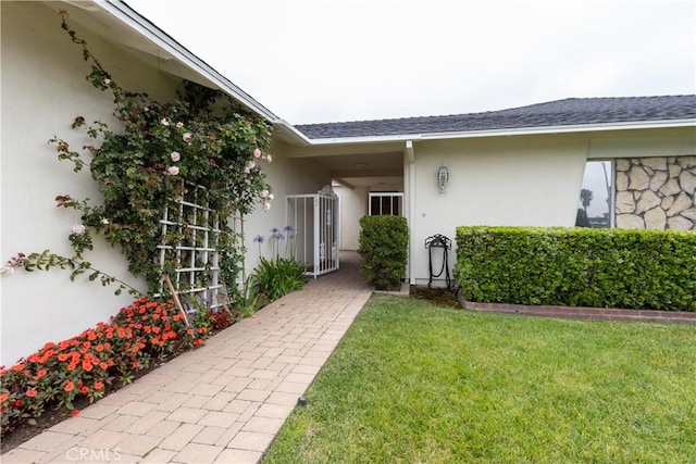 24912 Delos Ave, Mission Viejo, CA 92691 - view of exterior entry featuring stucco siding and a yard