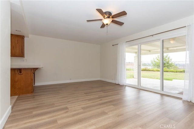 24912 Delos Ave, Mission Viejo, CA 92691 - unfurnished living room featuring ceiling fan, light wood-style floors, and baseboards