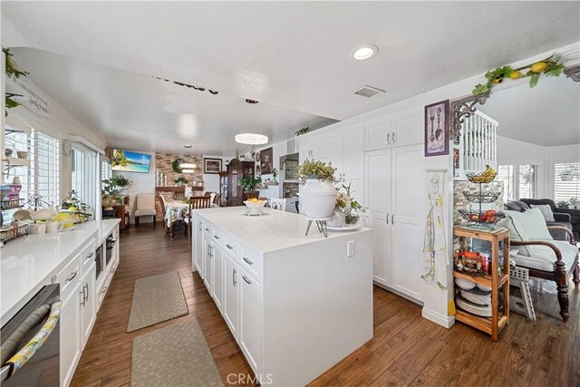 938 Amherst St, Corona, CA 92878 - kitchen featuring open floor plan, black dishwasher, white cabinetry, light countertops, and vaulted ceiling