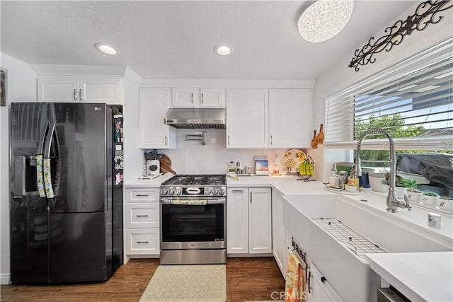 938 Amherst St, Corona, CA 92880 - kitchen featuring black fridge with ice dispenser, gas stove, under cabinet range hood, white cabinetry, and recessed lighting