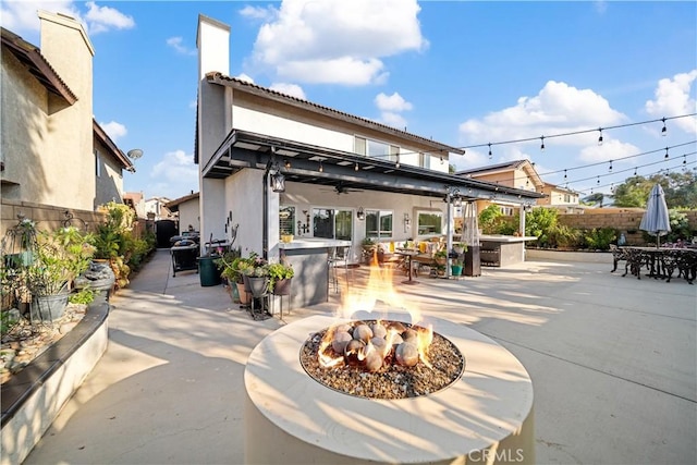 938 Amherst St, Corona, CA 92878 - rear view of house with an outdoor fire pit, a patio, a fenced backyard, ceiling fan, and stucco siding