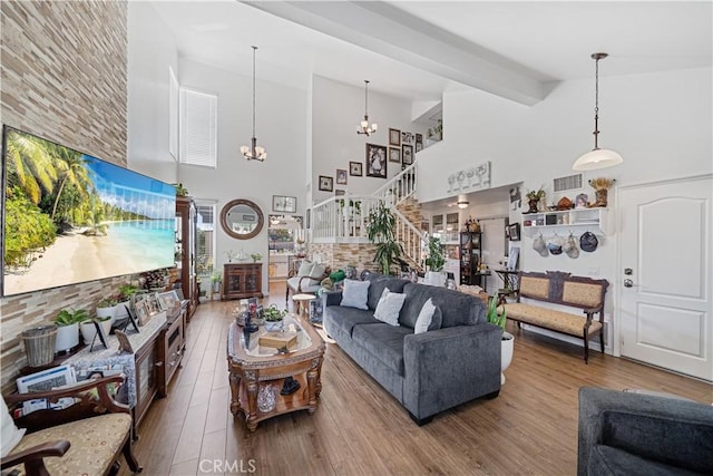 938 Amherst St, Corona, CA 92880 - living room with high vaulted ceiling, wood finished floors, beamed ceiling, stairs, and a chandelier