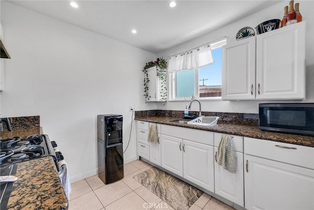 155 N Acacia Ave, Rialto, CA 92376 - kitchen with a sink, white cabinetry, recessed lighting, stainless steel range with gas stovetop, and light tile patterned flooring