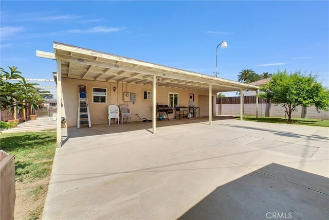 155 N Acacia Ave, Rialto, CA 92376 - rear view of house featuring stucco siding and a patio area