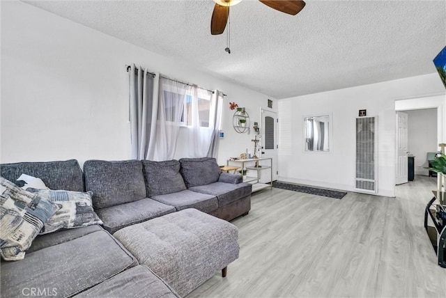 155 N Acacia Ave, Rialto, CA 92376 - living area featuring a heating unit, a ceiling fan, wood finished floors, a textured ceiling, and baseboards