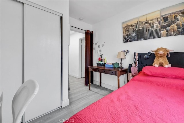 155 N Acacia Ave, Rialto, CA 92376 - bedroom with wood finished floors, a closet, and baseboards