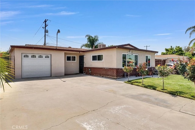 155 N Acacia Ave, Rialto, CA 92376 - single story home with stucco siding, an attached garage, driveway, and a front lawn