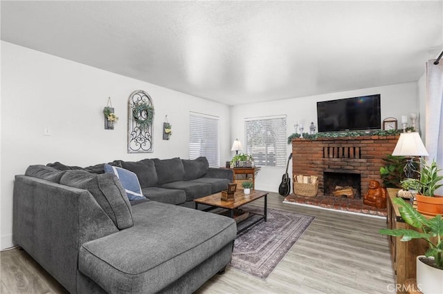 3360 Chico Rd, Atascadero, CA 93422 - living room with light wood-style floors and a brick fireplace