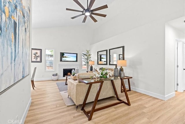 3176 Landmark Ct, Riverside, CA 92503 - living area featuring light wood-style floors, a brick fireplace, ceiling fan, and high vaulted ceiling