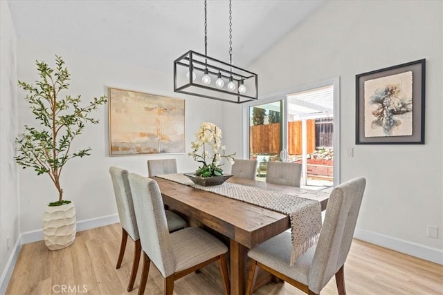 3176 Landmark Ct, Riverside, CA 92503 - dining room featuring a chandelier, light wood-type flooring, and lofted ceiling