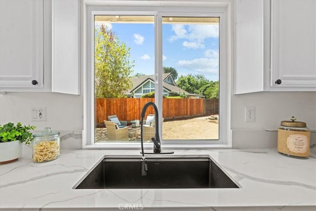 3176 Landmark Ct, Riverside, CA 92503 - kitchen featuring white cabinets and light stone counters