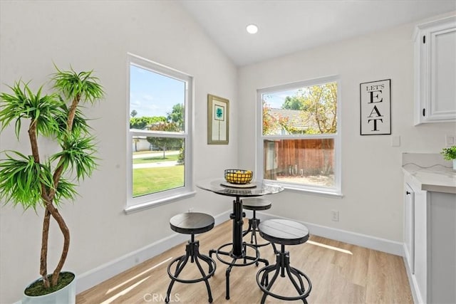 3176 Landmark Ct, Riverside, CA 92503 - dining room featuring light wood-type flooring, plenty of natural light, and vaulted ceiling