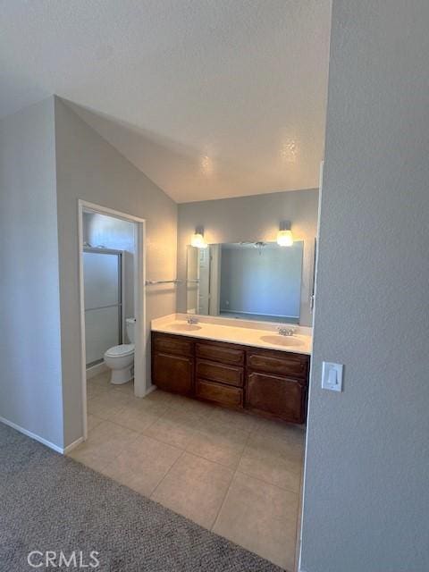 20826 Otowi Rd, Apple Valley, CA 92308 - full bathroom featuring double vanity, lofted ceiling, toilet, tile patterned floors, and baseboards