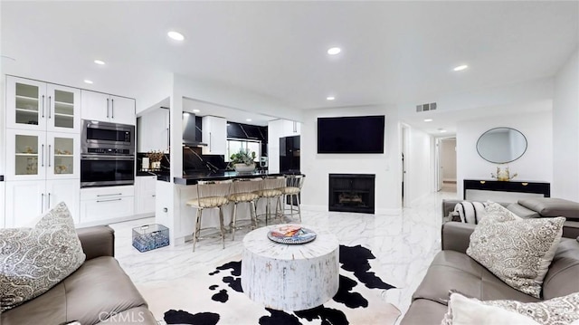 4632 Park Granada Unit 93, Calabasas, CA 91302 - living room with light marble finish flooring, recessed lighting, and a fireplace