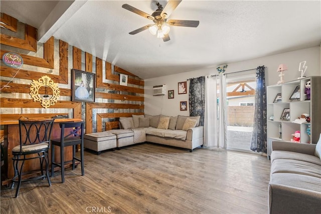 1126 W W Ave H6, Lancaster, CA 93534 - living area with wood finished floors, a ceiling fan, lofted ceiling, an AC wall unit, and a textured ceiling
