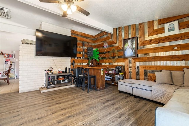1126 W W Ave H6, Lancaster, CA 93534 - living area with a ceiling fan, wooden walls, wood finished floors, and a textured ceiling