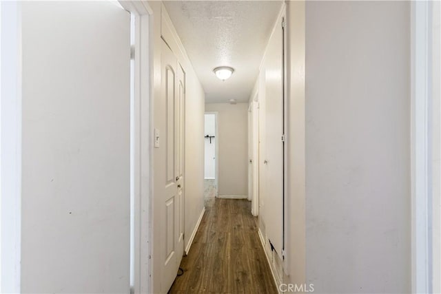 1126 W W Ave H6, Lancaster, CA 93534 - hallway featuring a textured ceiling and dark wood-style flooring